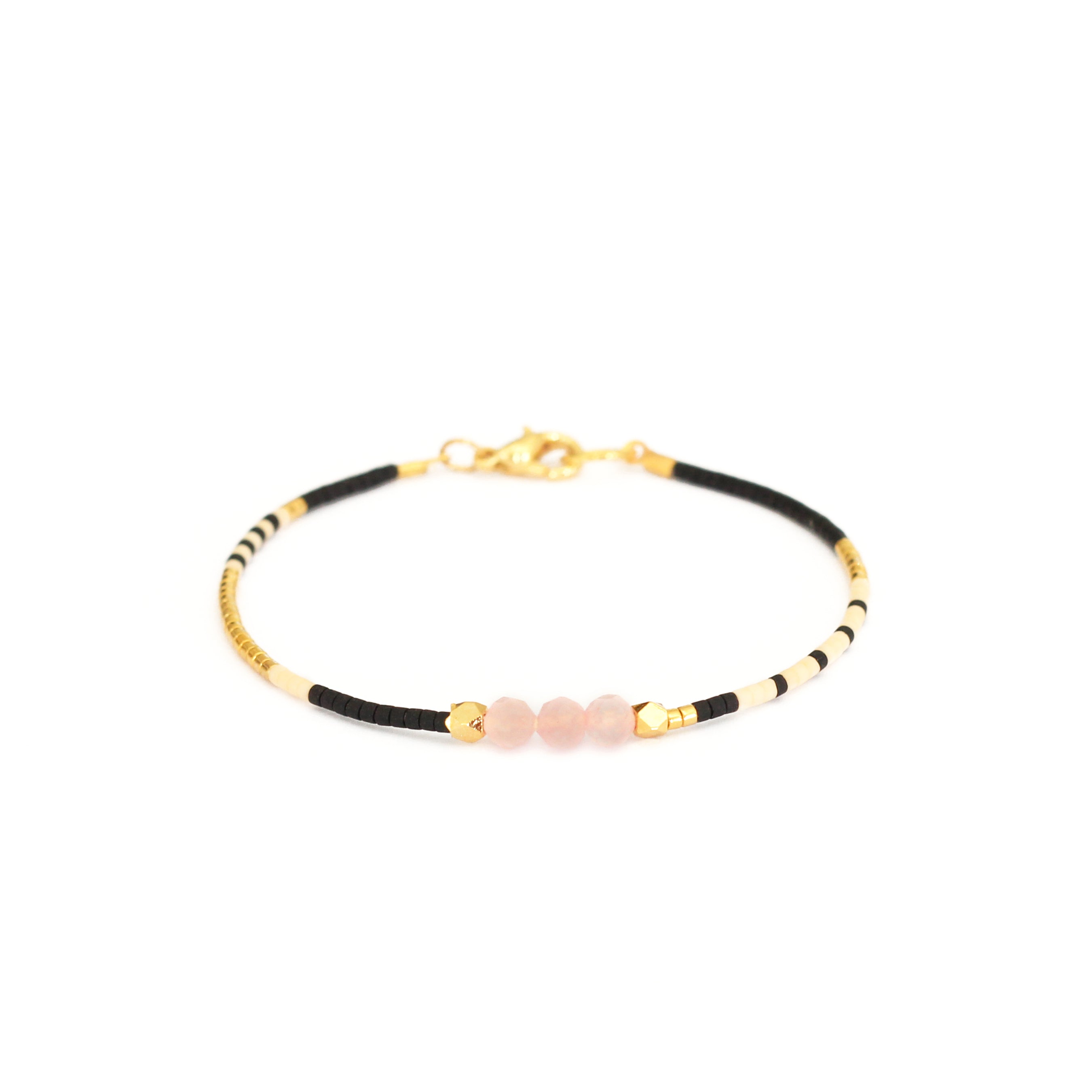 Black, white and gold beaded pink quartz bracelet
